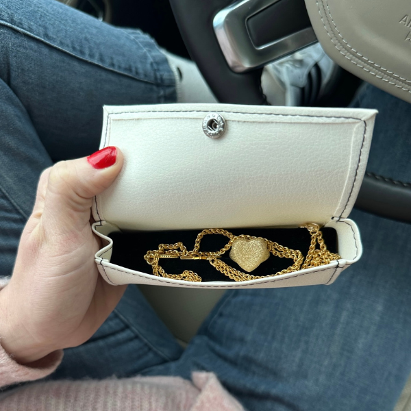 Hand holding Purse Pouch Open with Jewelry Tucked into it