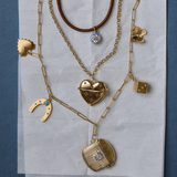 Copper Clasp Cord Necklace with Blue Enamel Bezel Charm, Heart Vesta Case Necklace, Long Link Chain with Small Heart of Gold Charm, Law of Attraction Magnet, Ribbed Vesta Case, Cosmic Dice Charm, and Butterfly Charm