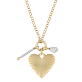 A gold-plated Percy Clip Necklace with three charms, including a matchstick, a ribbed heart, and a pearl-like charm, attached to a gold-filled chain.