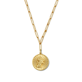 Gold necklace with a round pendant on a white background