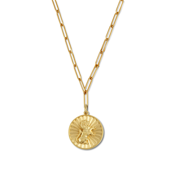 Gold necklace with a round pendant on a white background
