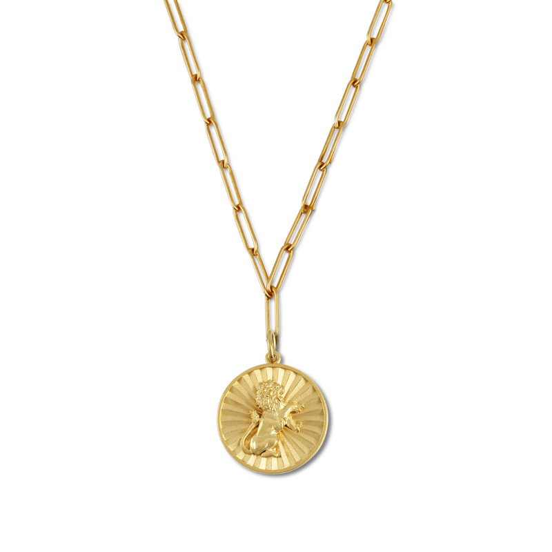 Gold necklace with a round pendant on a white background