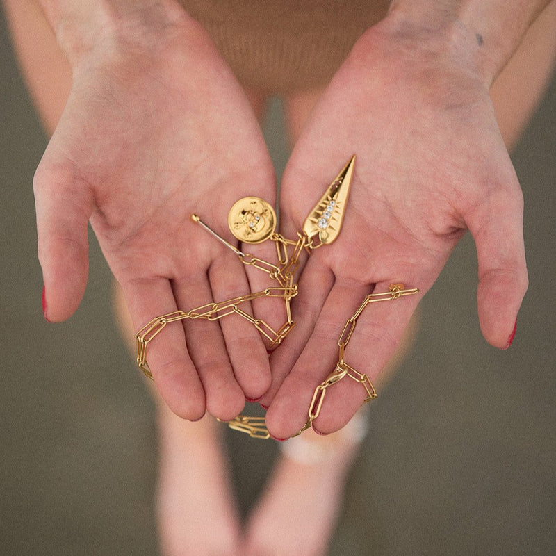 charm on hands at beach