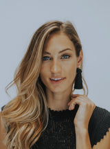 Hart black tassel earrings on model